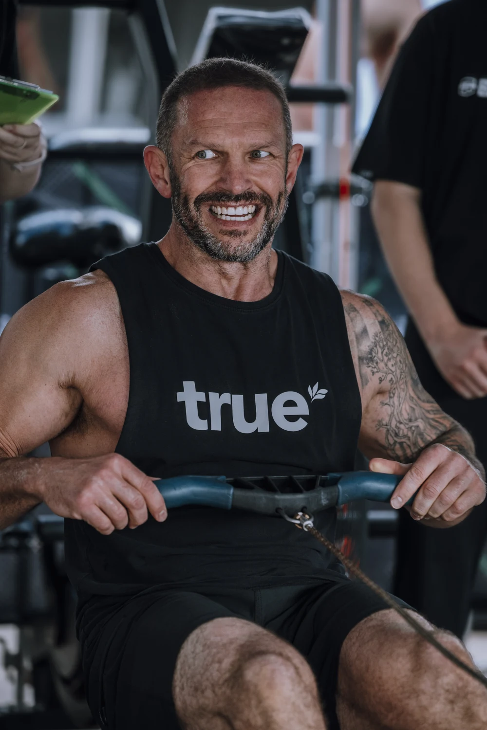 An athlete smiling while rowing at a previous Benton competition
